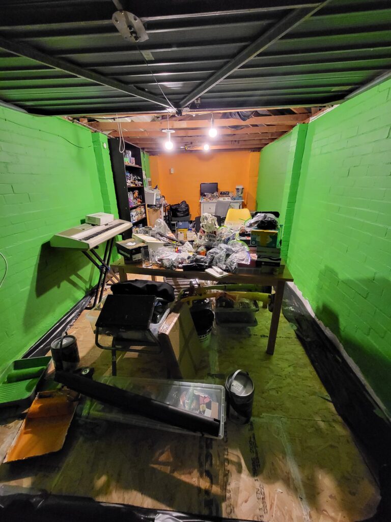 An image of the garage with the walls painted green and orange.